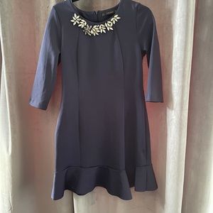 Jewel detail Navy dress with ruffle bottom.